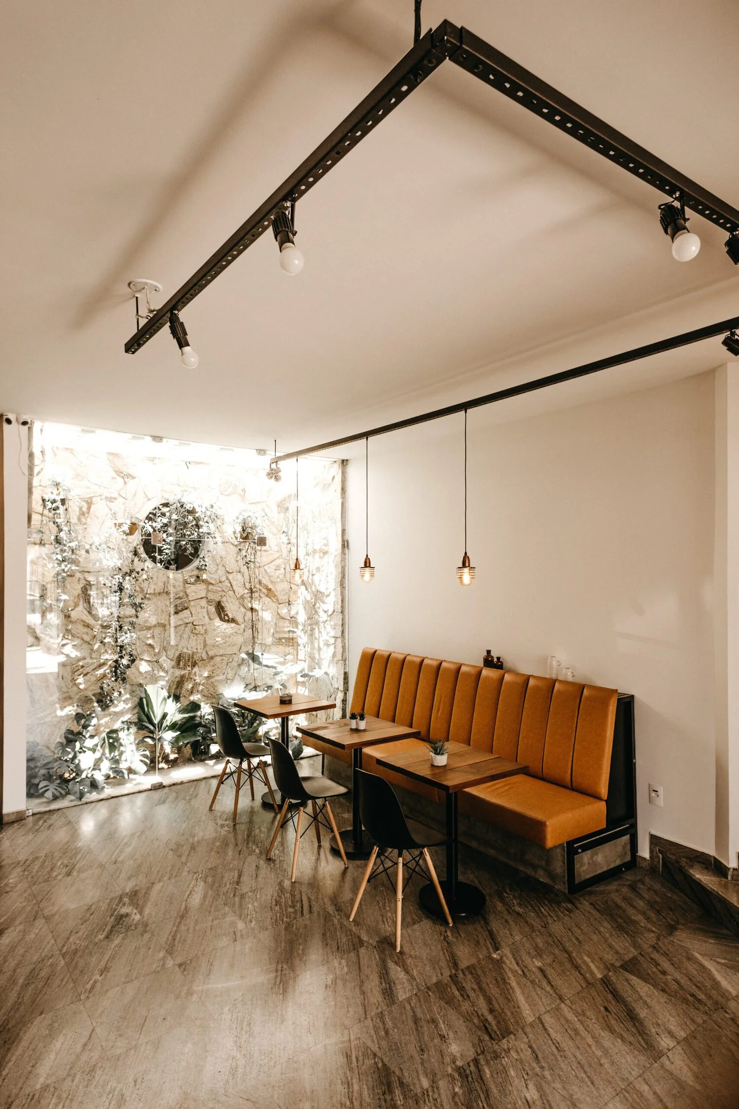 cafe-interior-with-orange-sofa-three-tables-three-black-chairs-scaled Thiết Kế Quán Cafe